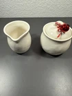 Dei Cream Pitcher And Sugar Jar Ceramic Set With Red Bells Used. Price: $14.36.