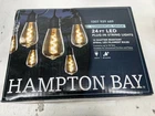 Hampton Bay 12-LIGHT 24 Ft. Outdoor/indoor Black Plug-in ST64 Led String Open. Price: $34.95.